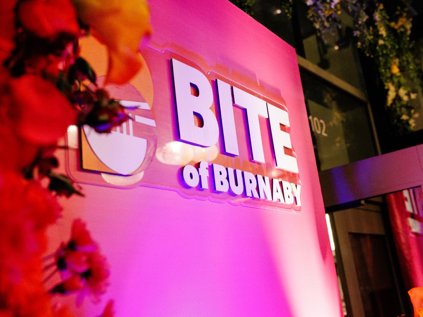 Bite of Burnaby festival sign lit in pink