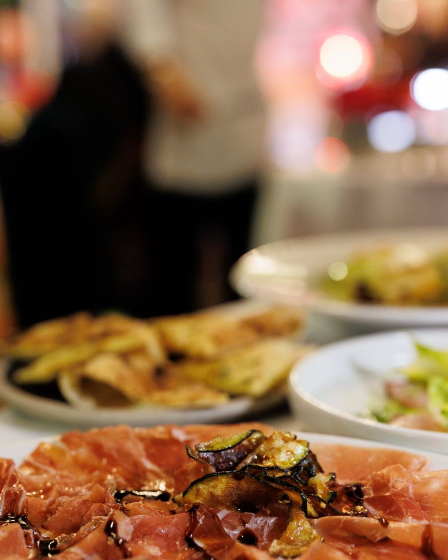 Plates of prosciutto and small dishes at the launch event