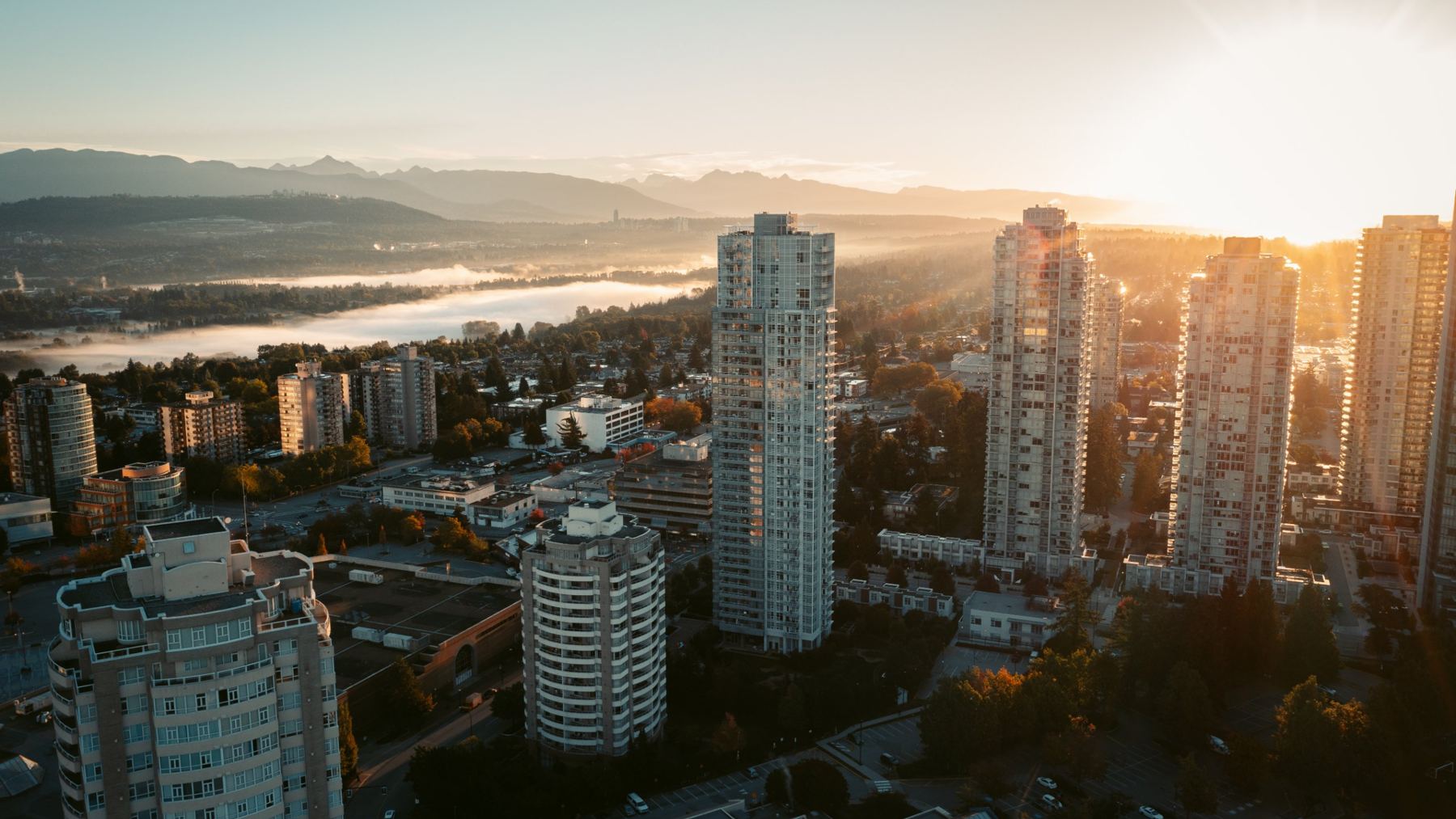 Metrotown skyline at sunrise with mountains behind