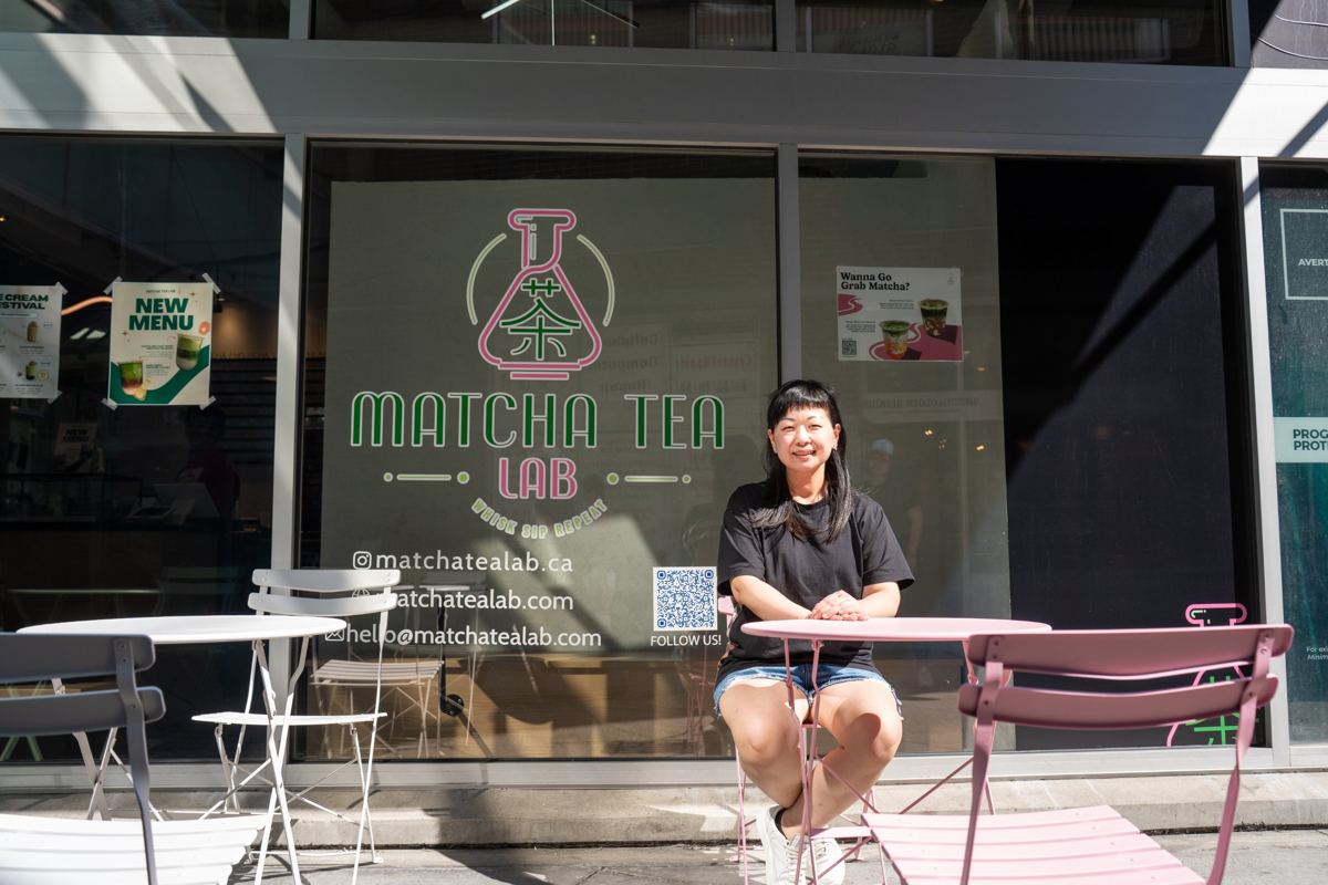 Owner of Matcha Tea Lab seated outside her shop